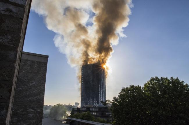 Smoke billows from a fire that has engulfed the 27-storey Grenfell Tower in west London. PRESS ASSOCIATION Photo. Picture date: Wednesday June 14, 2017. More than 200 firefighters were sent to tackle the blaze and London Ambulance Service said 30 people 