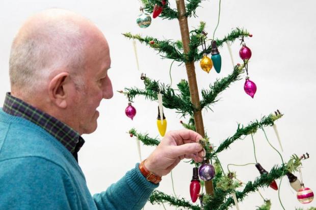 BUSY: Steve Rose decorating the tree. Picture: Hansons